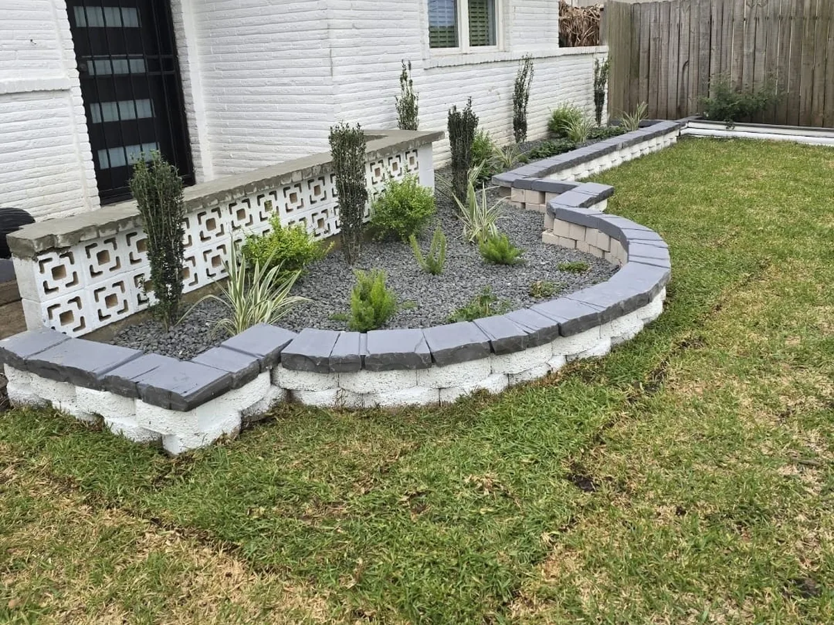 Stone-edged flower bed and fresh lawn at a front entry