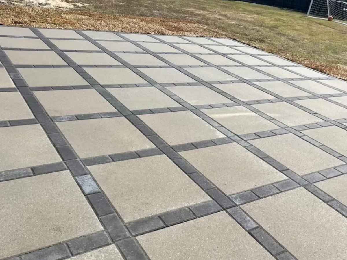Clean square concrete pavers laid in a grid