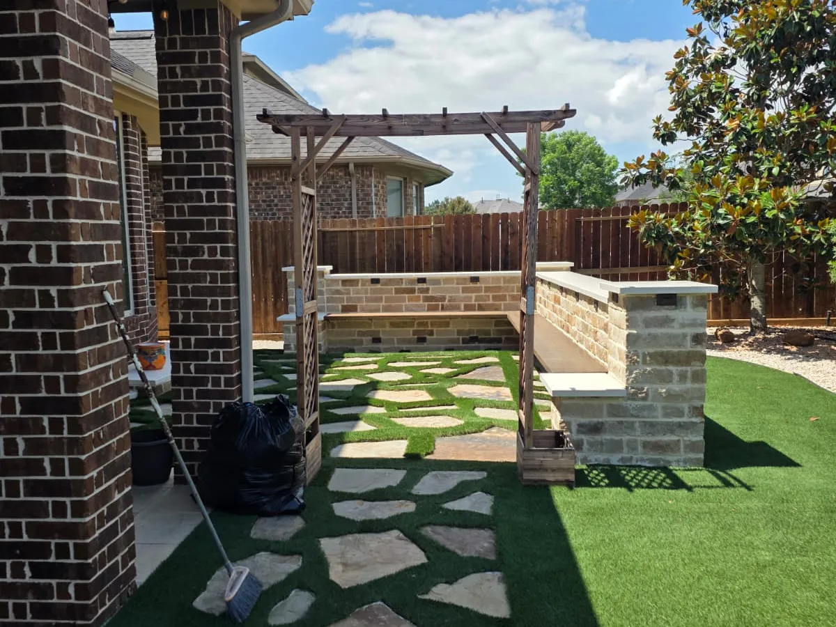 Artificial turf with flagstone steps and a pergola